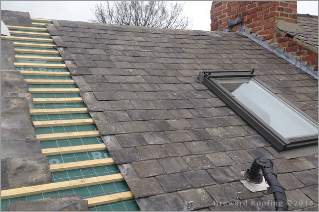 Re-roofing in progress, tiling around a roof window