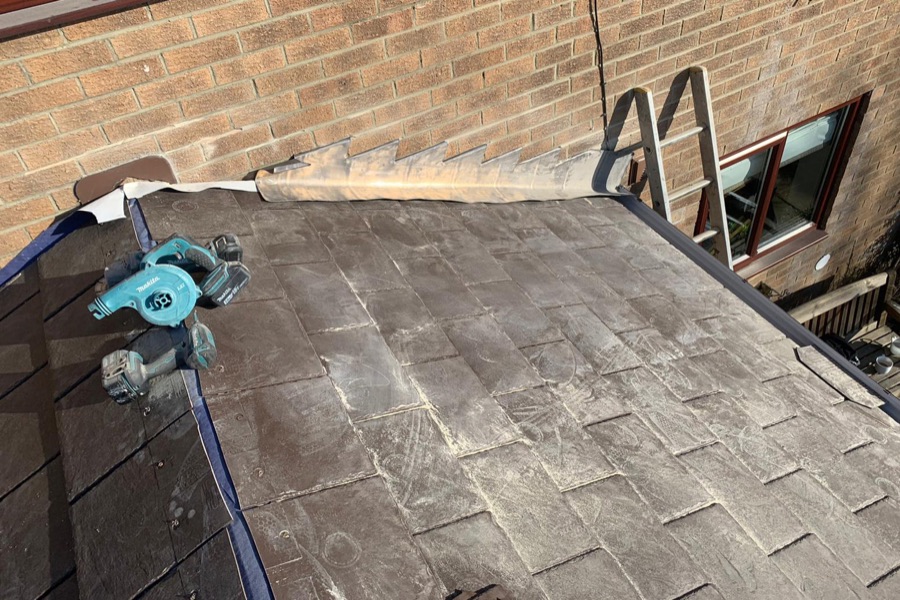 Lead valley flashing repair beside a chimney stack